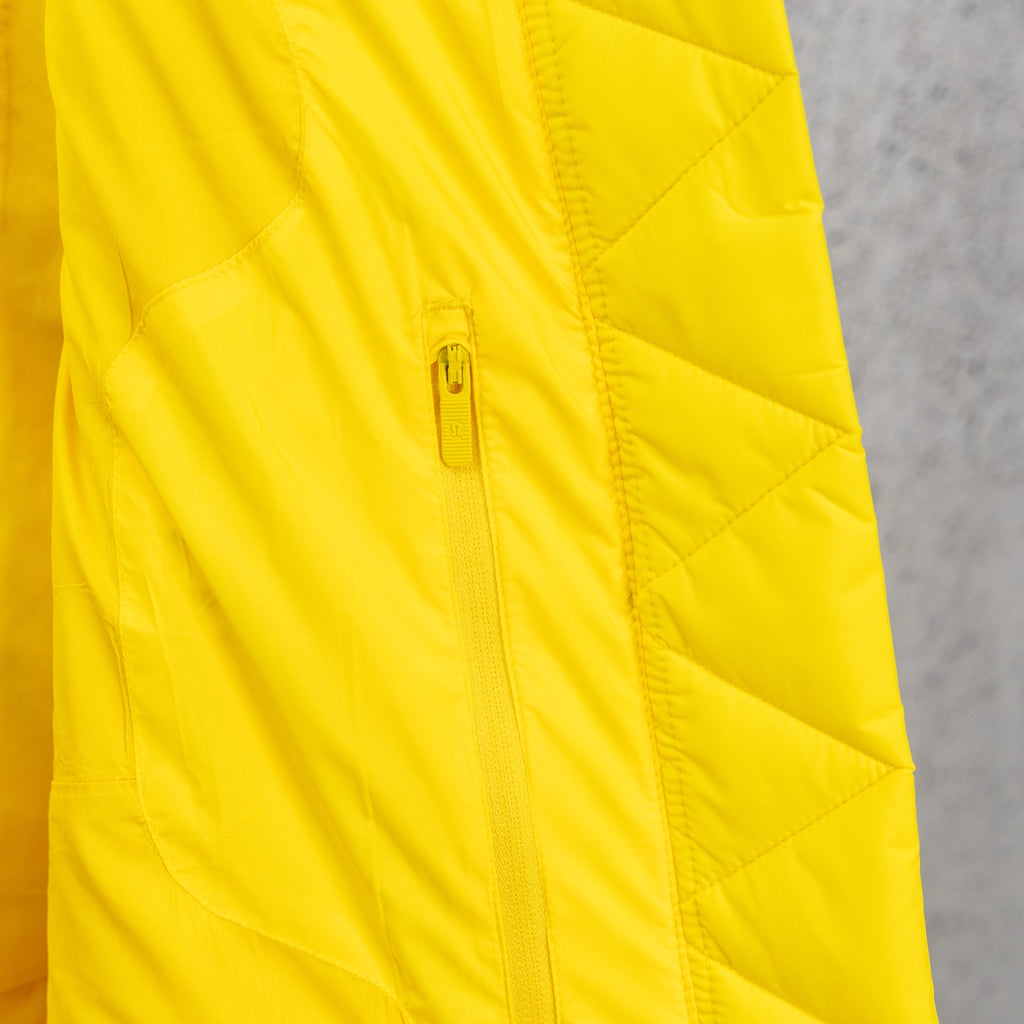 Yellow puffer jacket with front zipper and quilted panels