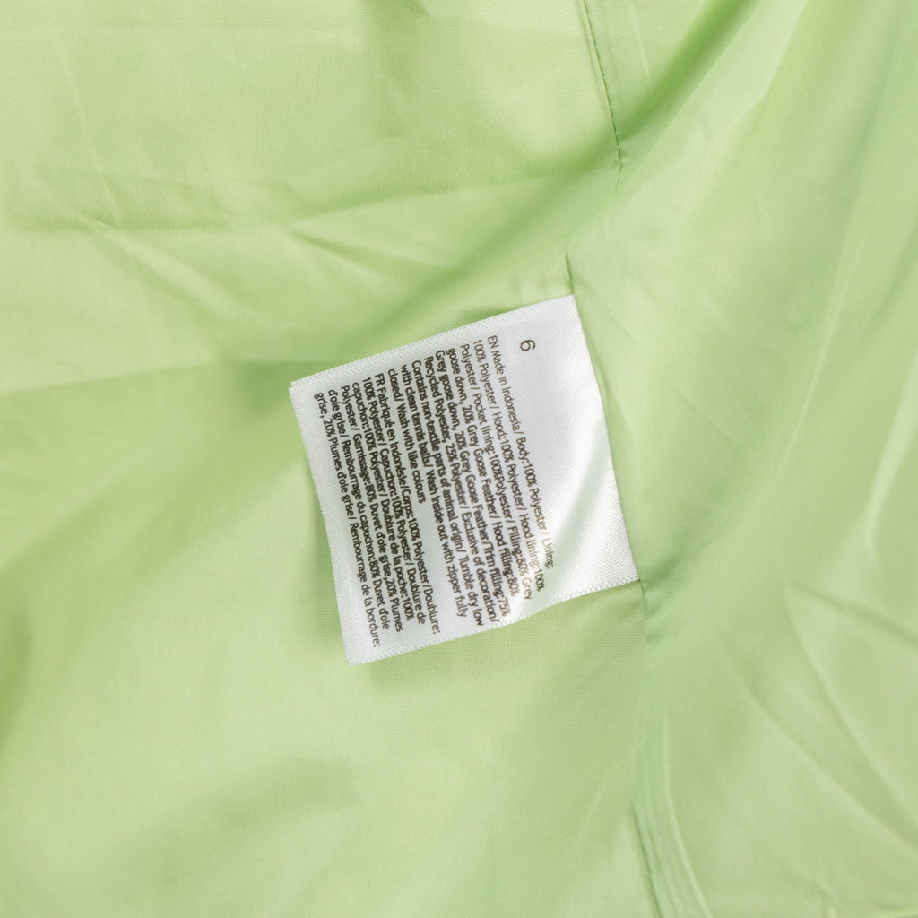 Light green puffer jacket label patch at inner collar