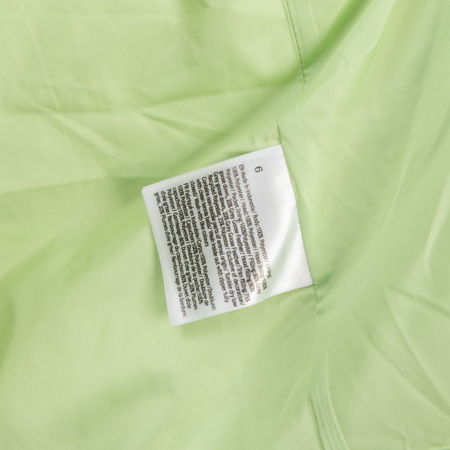 Light green puffer jacket label patch at inner collar