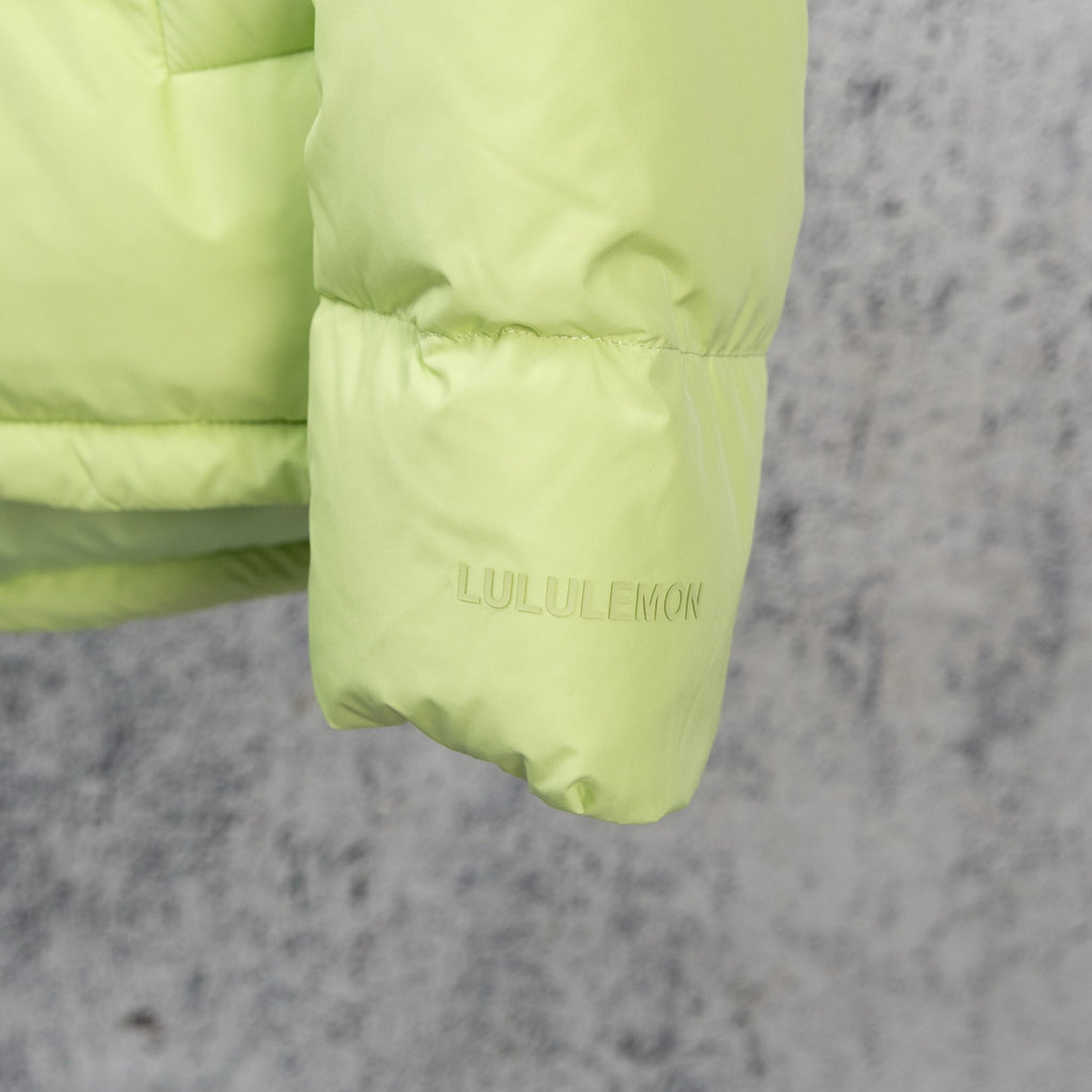 Lime green puffer jacket cuff with LULULEMON logo print
