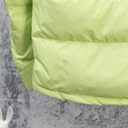 Light green puffer jacket sleeve cuff and front quilting with small logo