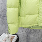 Lime green puffer jacket sleeve and front quilted panel detail
