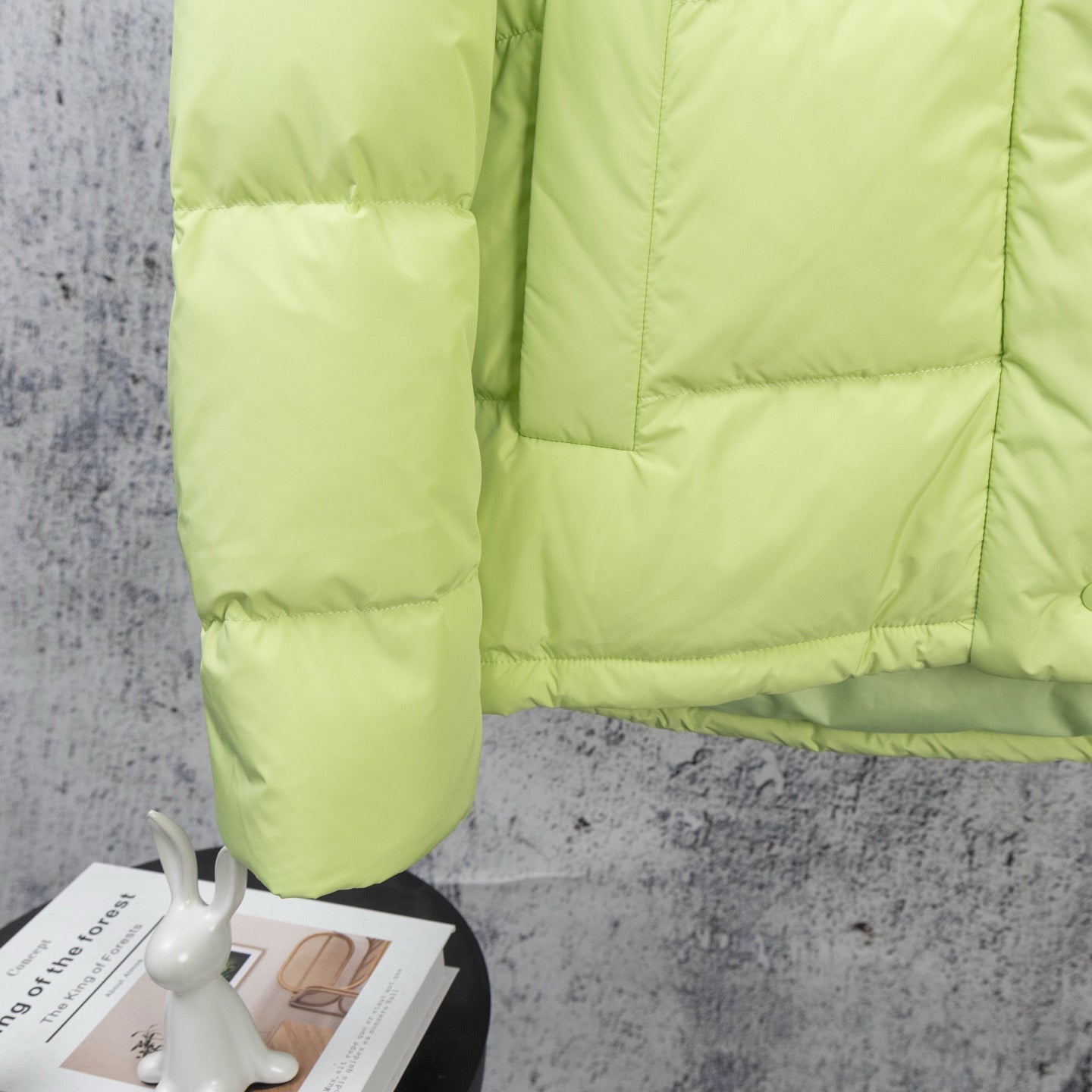 Lime green puffer jacket sleeve and front quilted panel detail