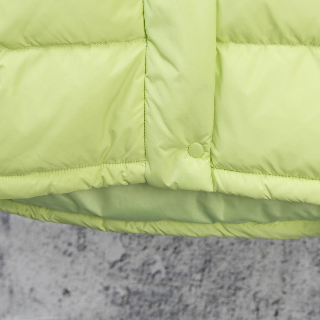 Lime green puffer jacket hem with snap button and channel quilting