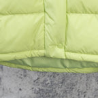 Lime green puffer jacket hem with snap button and channel quilting