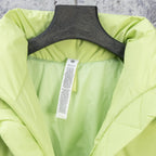 Lime green puffer jacket with inside label tag visible at neckline