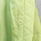 Lime green puffer jacket front seam with center zipper and quilted panels