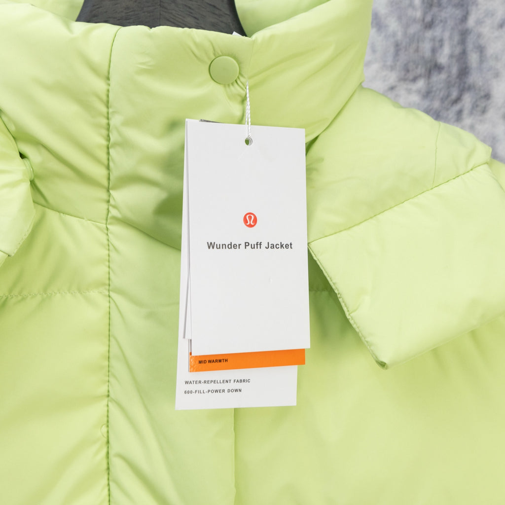 Lime green puffer jacket with front button placket and hanging product tags