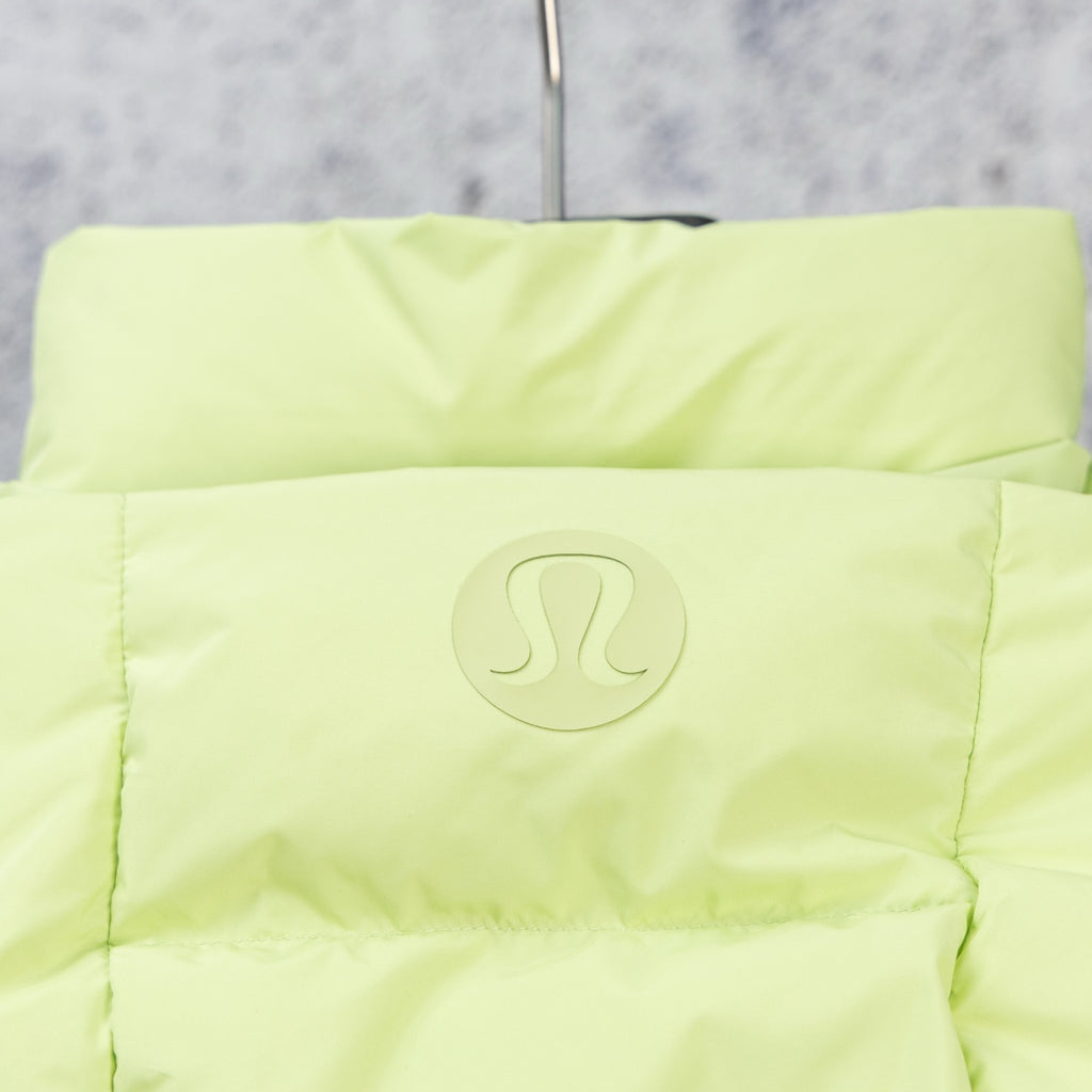 Light green hooded puffer jacket with circular chest logo