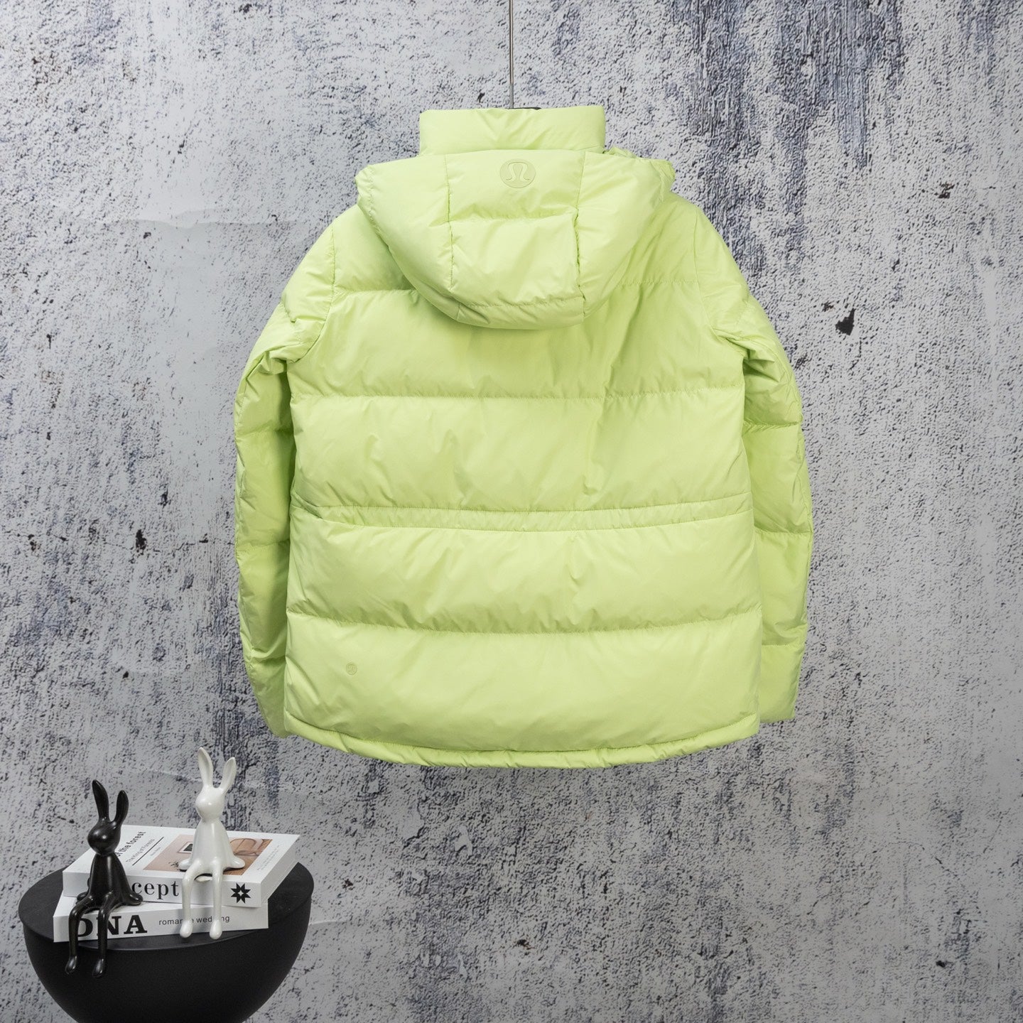 Lime green puffer jacket with hooded back and horizontal quilted panels