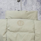 Beige hooded puffer jacket with circular logo patch on upper back