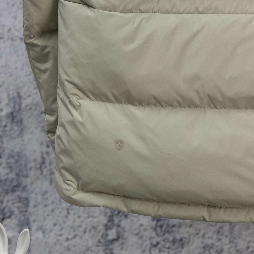 Beige puffer jacket front panel with small logo and stitched trim