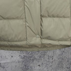Light olive puffer jacket hem with center button and quilted panel seams