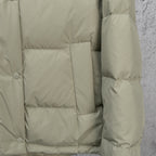 Light olive puffer jacket interior view with quilted panels and sleeve cuff