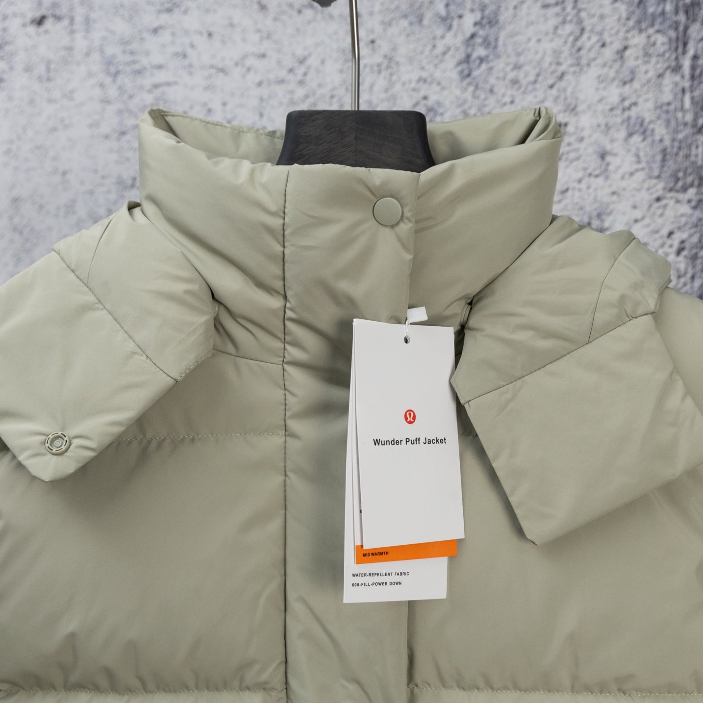 Light olive hooded puffer jacket with front button and sleeve tabs