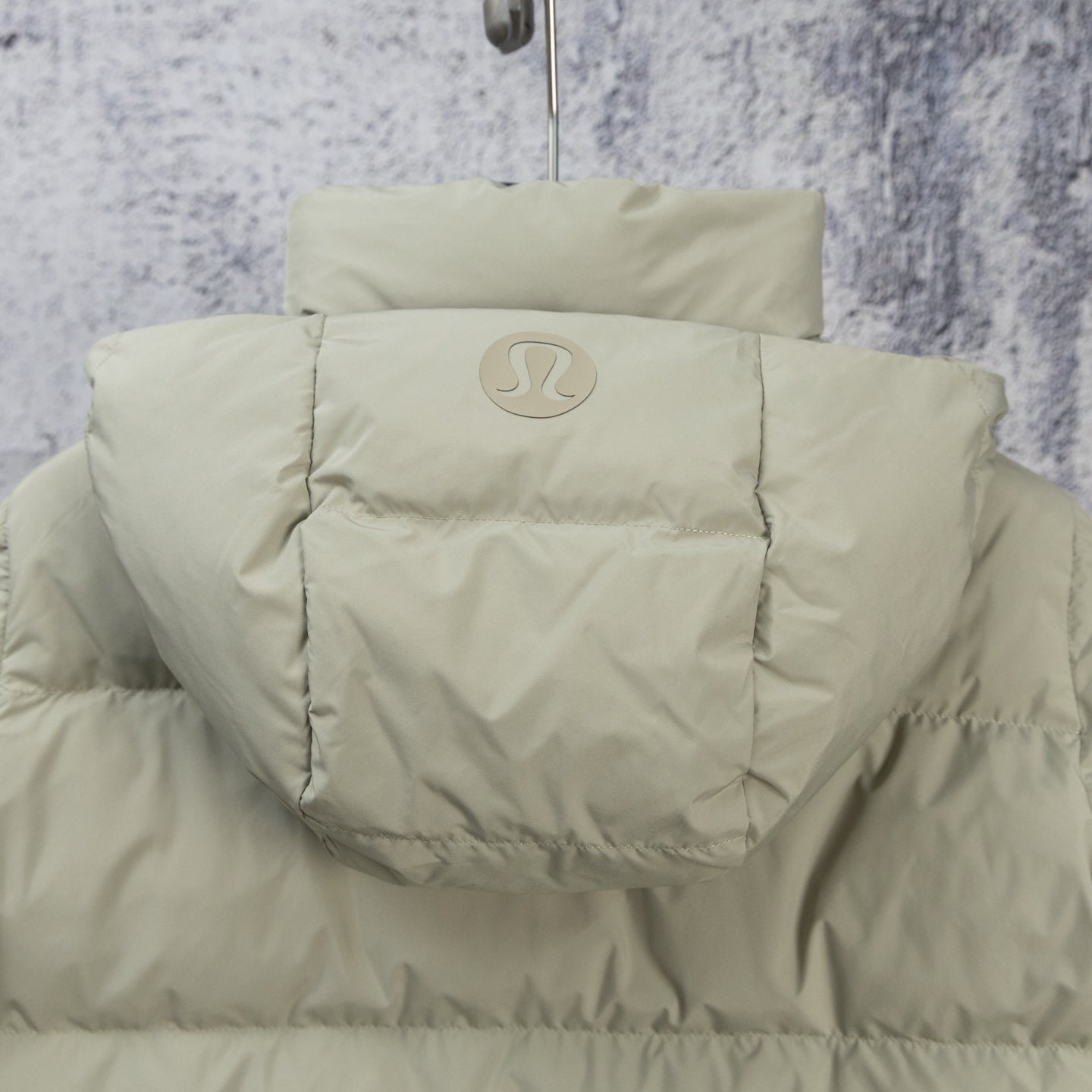 Beige hooded puffer jacket with back logo and quilted shoulder panels