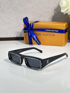 Black rectangular eyeglasses with gold accents and dark lenses