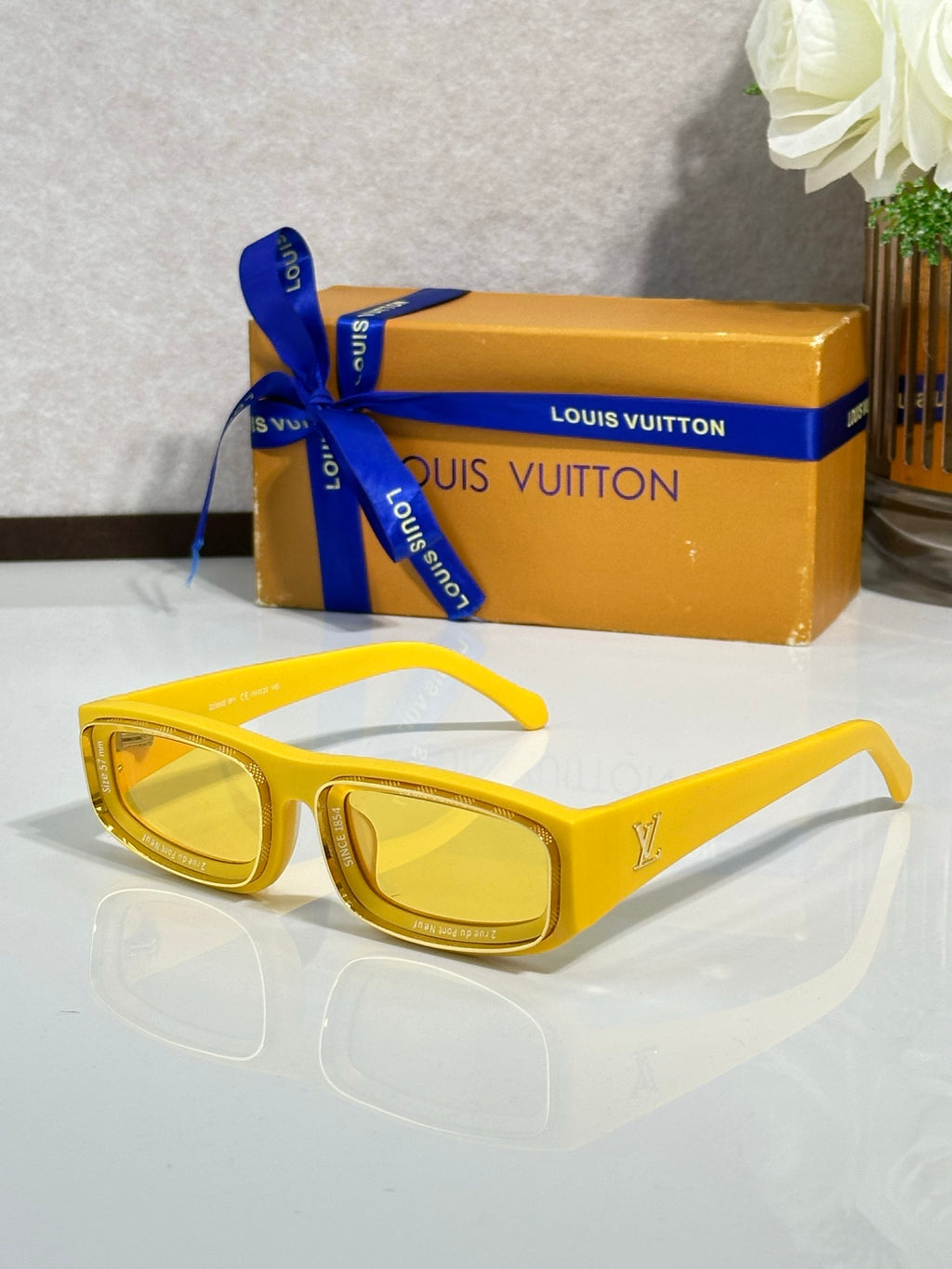 Yellow rectangular eyeglasses with glossy frames and yellow-tinted lenses
