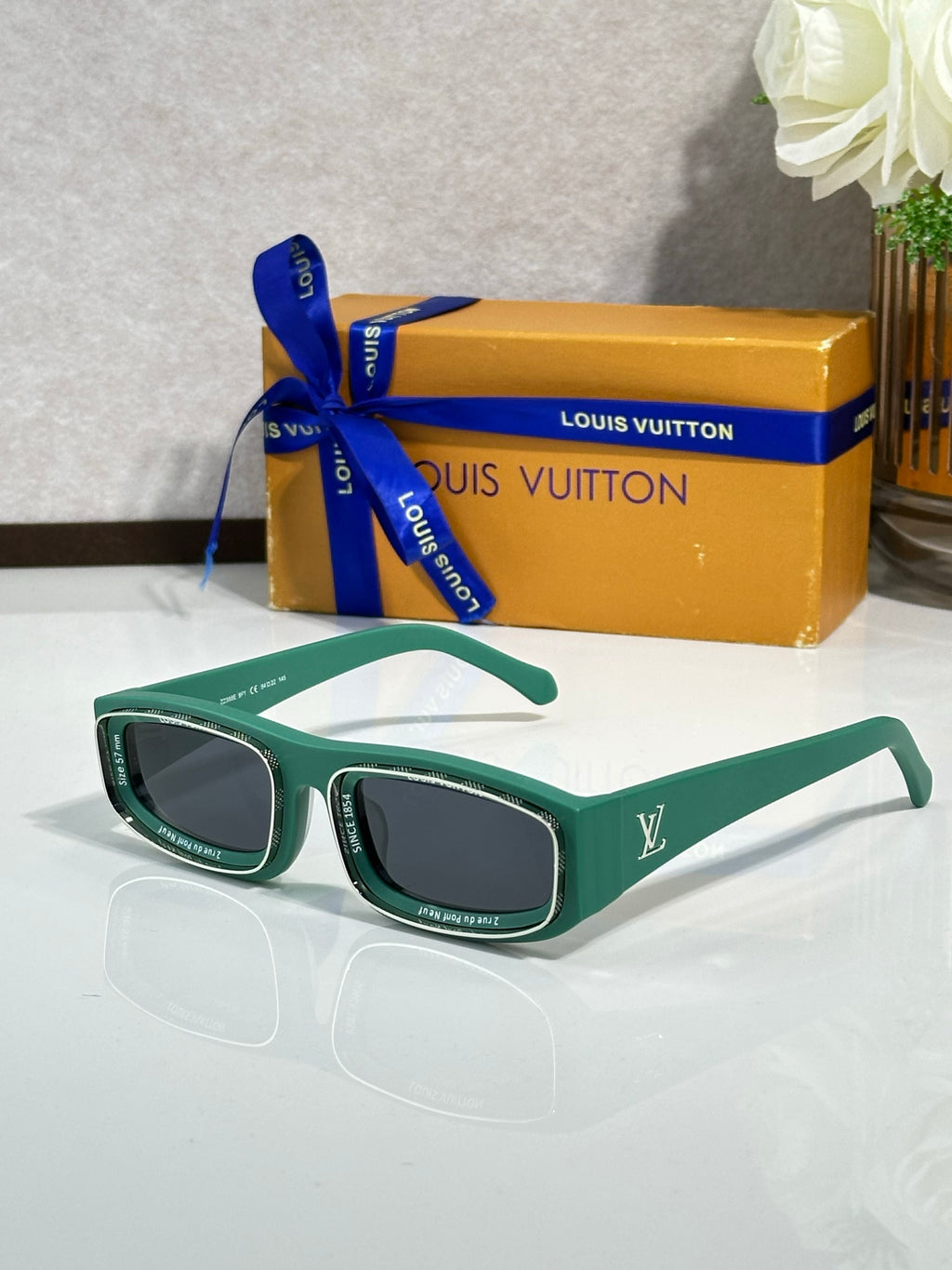 Green rectangular eyeglasses with glossy frames and dark lenses