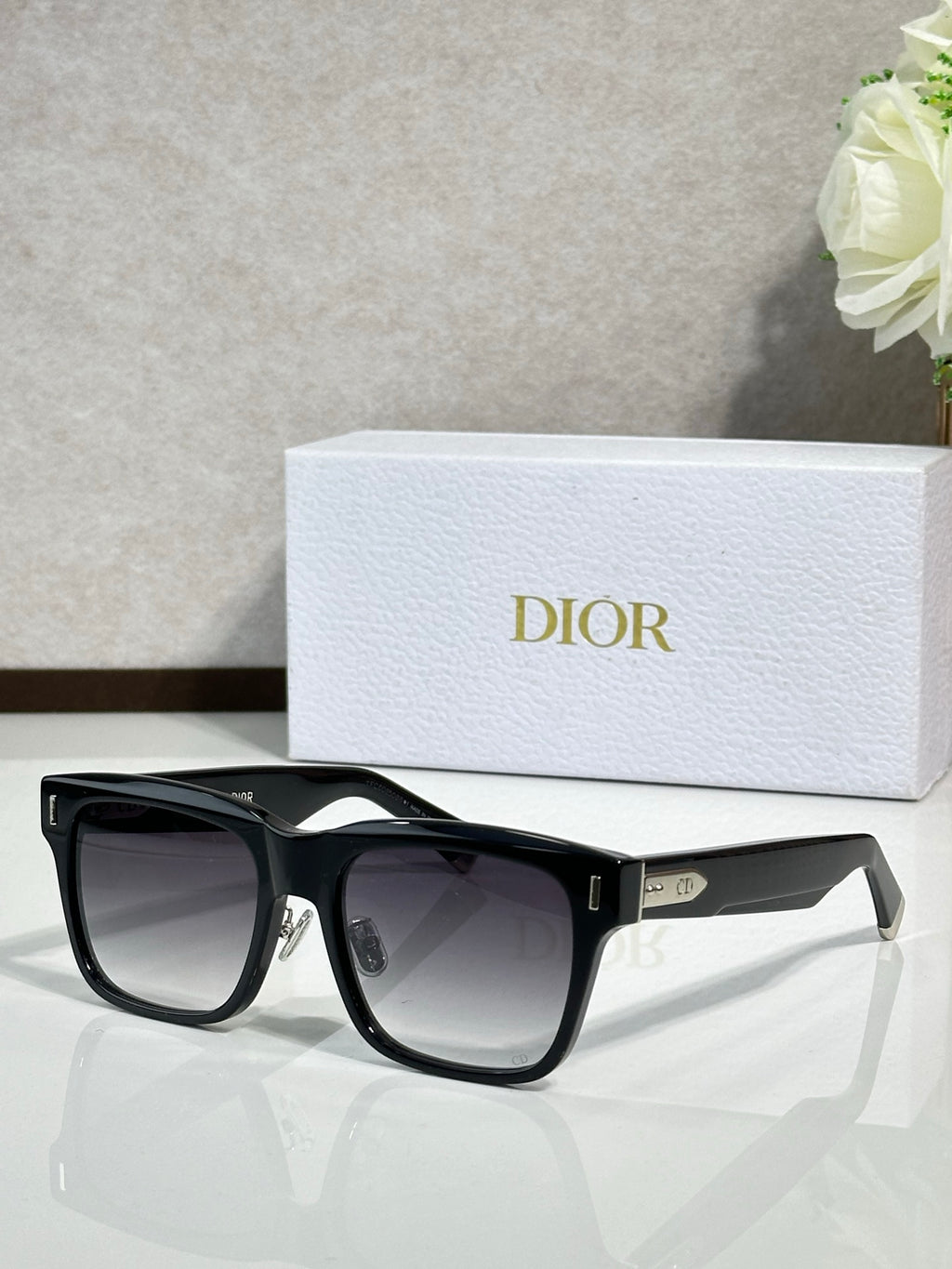 Dior sunglasses with black frames and dark lenses, front view