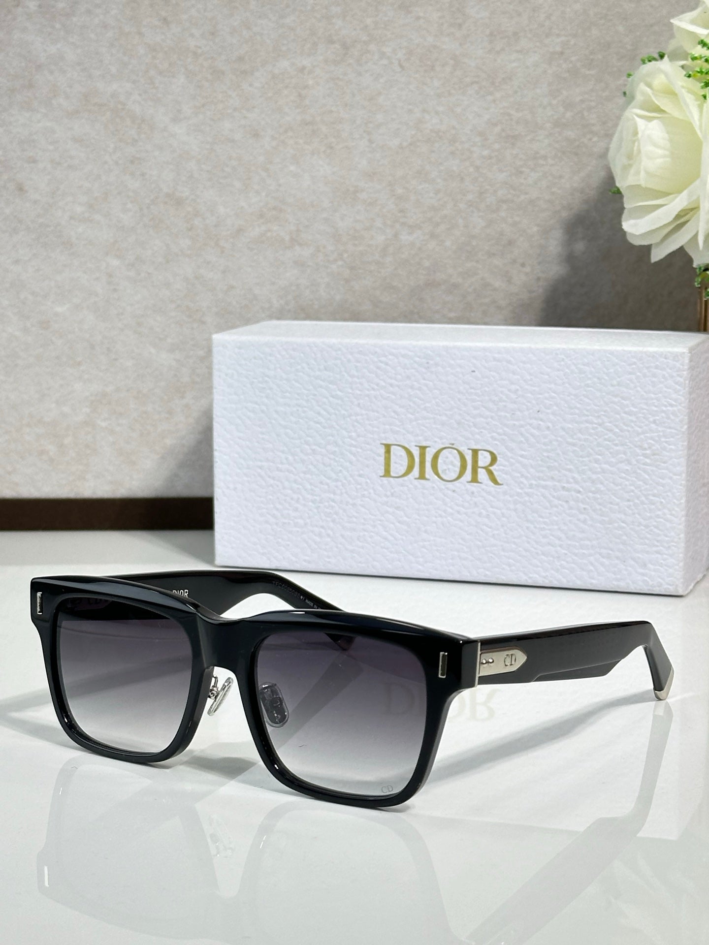 Dior sunglasses with black frames and dark lenses, front view