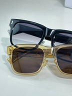 Dior sunglasses set: gold and black frames with dark lenses, close-up