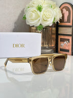Dior sunglasses with gold frames and brown lenses, angled front view