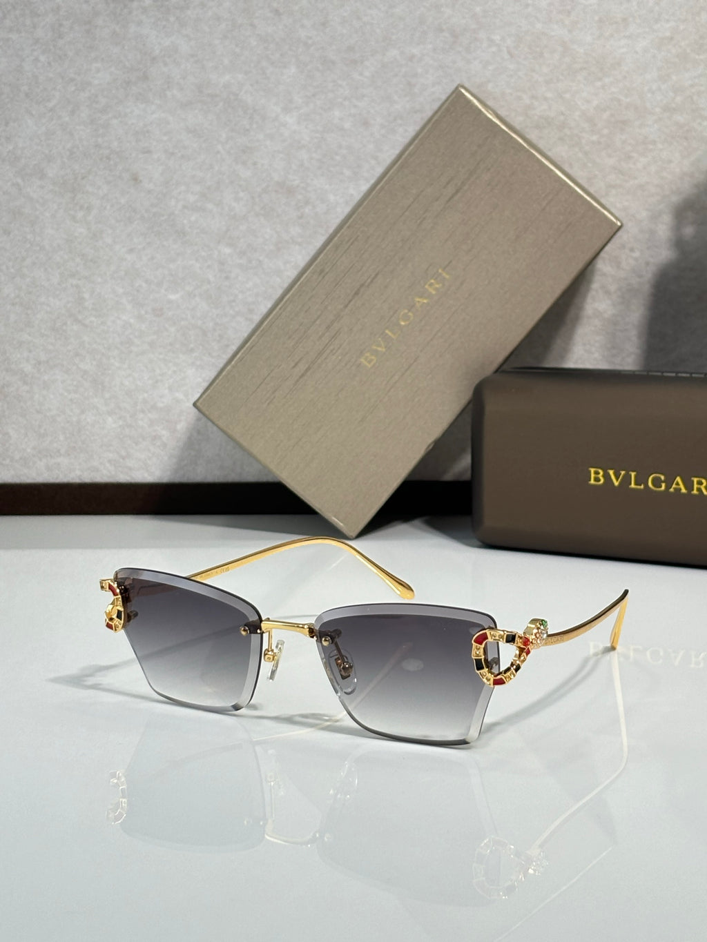 Bvlgari eyeglasses with gray tinted lenses and gold-tone frame