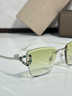Close-up of Bvlgari eyeglasses with light green tinted lens and metal frame