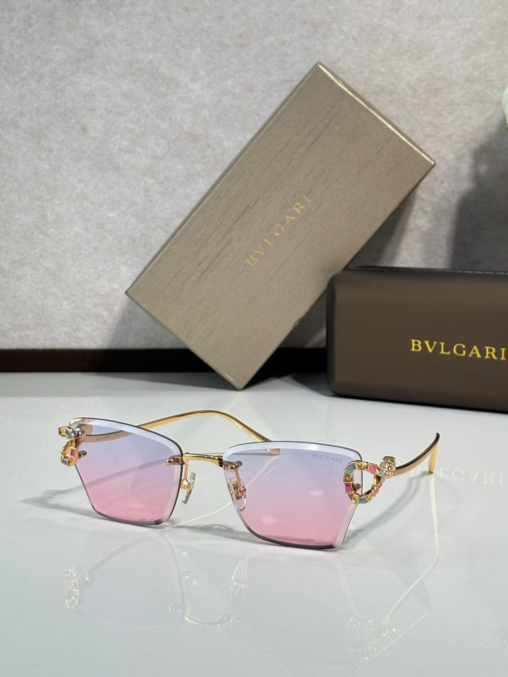 Bvlgari eyeglasses with pink tinted lenses and gold-tone frame