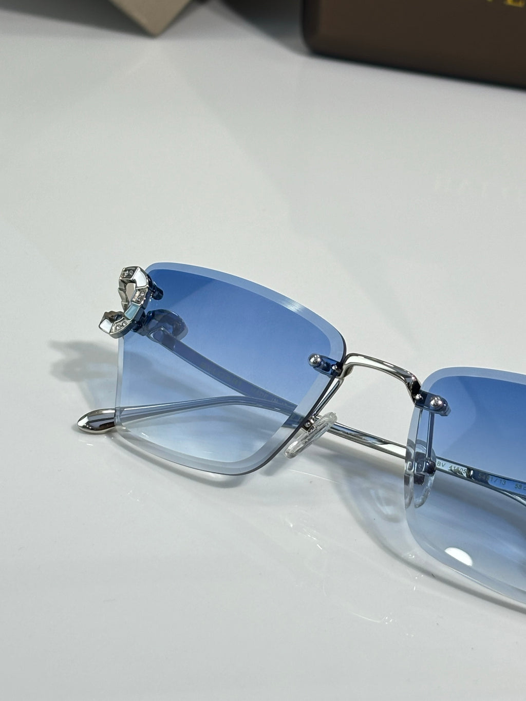 Close-up of Bvlgari eyeglasses with blue tinted lens and metal frame
