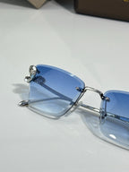 Close-up of Bvlgari eyeglasses with blue tinted lens and metal frame