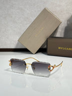 Bvlgari sunglasses with dark tinted lenses and gold frame with jeweled temple detail