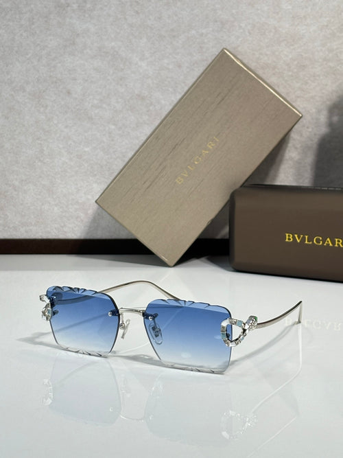 Bvlgari sunglasses with blue tinted lenses and silver frame with jeweled accents