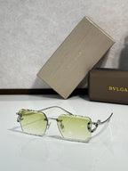 Bvlgari sunglasses with light green tinted lenses and silver frame with jeweled details