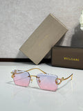 Bvlgari sunglasses with pink tinted lenses and gold frame with jeweled temple details
