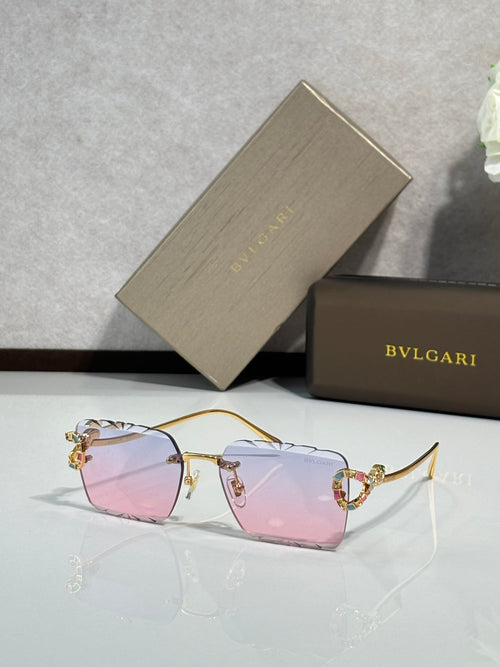 Bvlgari sunglasses with pink tinted lenses and gold frame with jeweled temple details