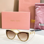 MiuMiu cat-eye sunglasses with cream frames and brown lenses.