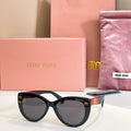 MiuMiu cat-eye sunglasses with black frames and dark lenses.