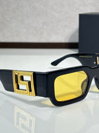 Rectangular sunglasses with black frames, yellow lenses, gold logo front temple detail