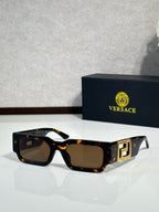 Rectangular sunglasses with tortoiseshell frames, dark lenses, gold logo temple detail