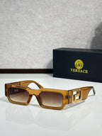 Rectangular sunglasses with amber brown frames, brown tinted lenses, gold logo temples