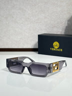 Rectangular sunglasses with dark brown frames, smoky gray lenses, gold temple accents