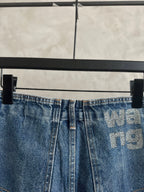 Light blue denim pants, button-and-zip front, waistband logo print