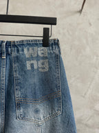 Light blue denim pants back patch pocket with large 'we...ng' graphic