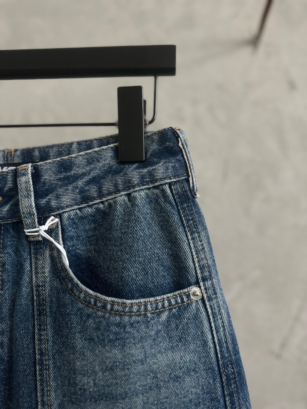 Blue denim pants with side pocket and attached belt loop detail