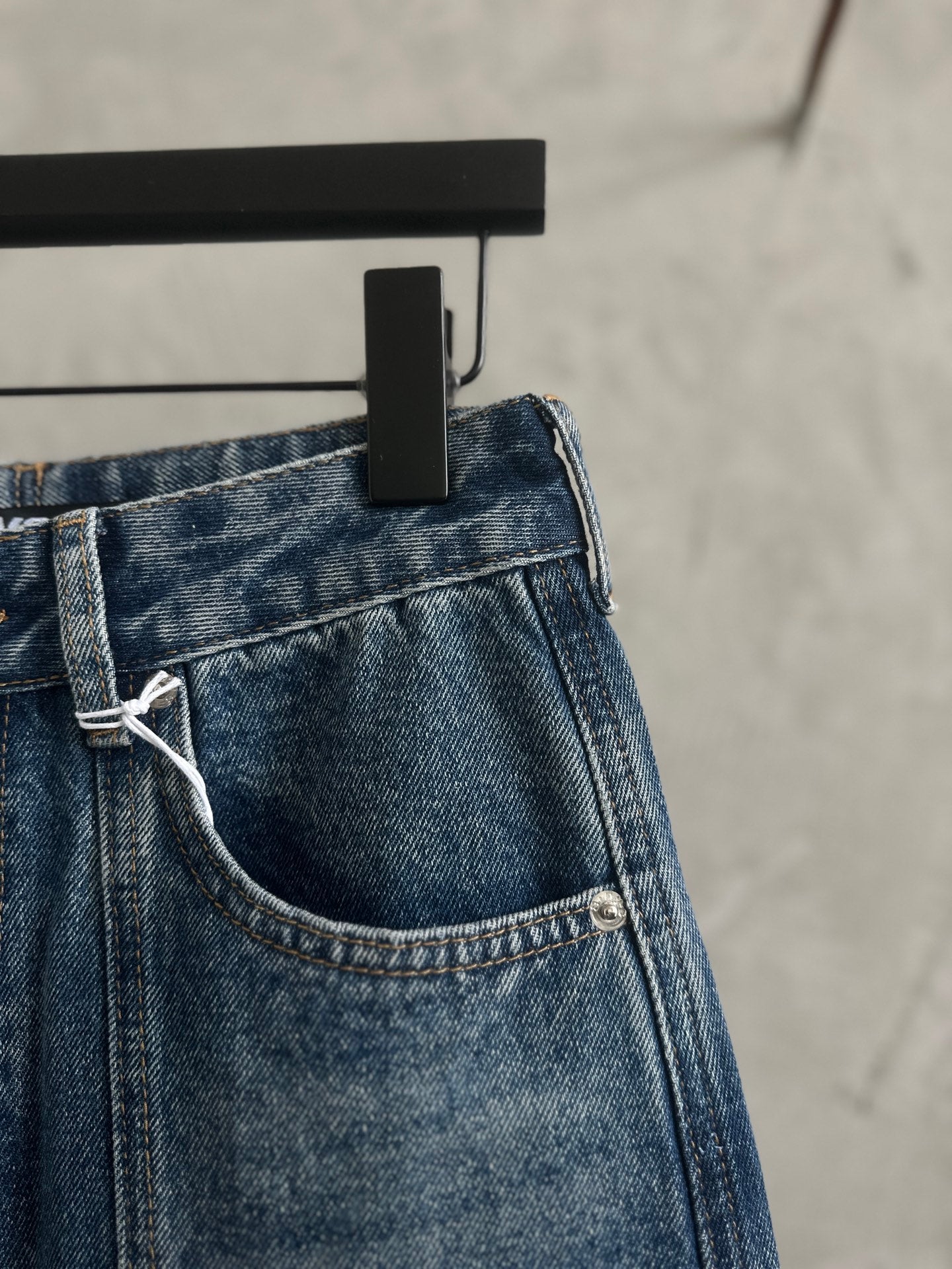 Blue denim pants with side pocket and attached belt loop detail