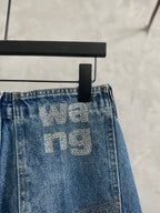 Light blue denim pants waistband with large 'We' graphic and belt loops