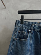 Blue denim pants with front pockets and metal-button closure