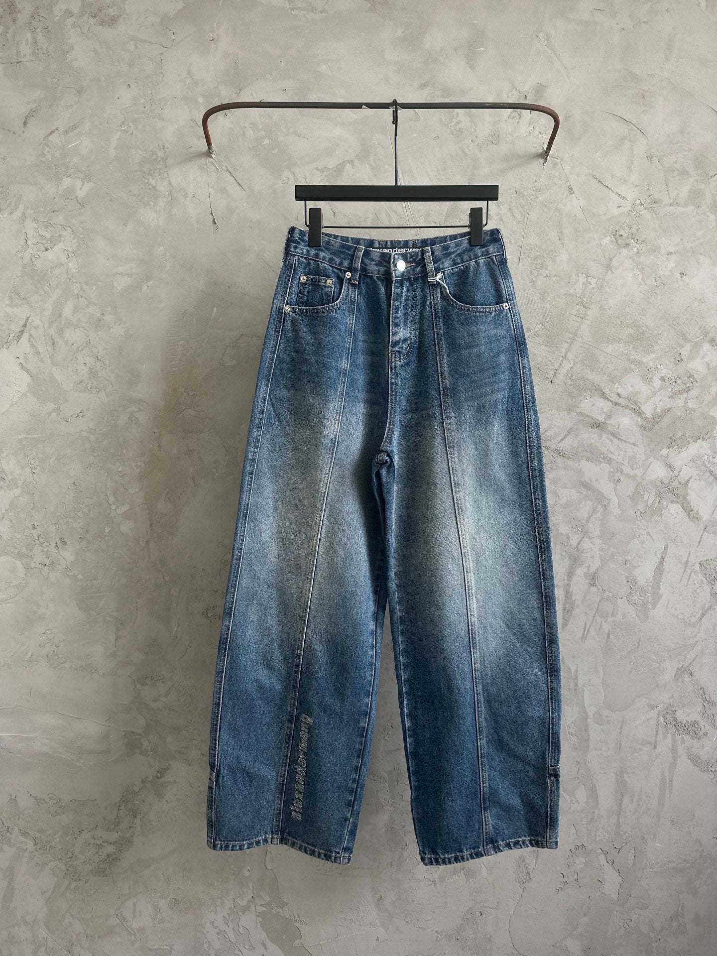 Blue denim wide-leg pants with button front and belt loops